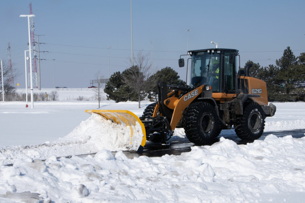 arctic snow and ice sectional snow plow plowing snow wheel loader copy