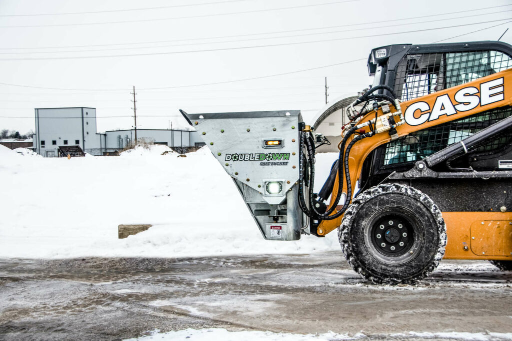1-yard DoubleDown salt bucket attachment on a skid loader in Western Canada for Arctic Snow and Ice Control