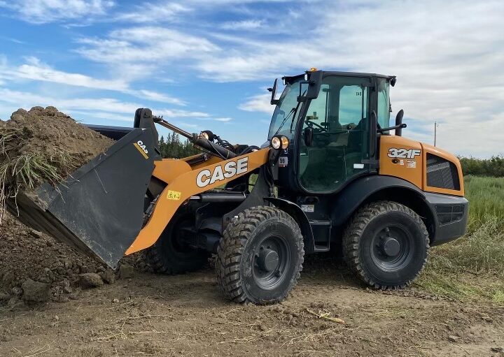 CASE 321F wheel loader moving dirt in a construction site for heavy equipment rental in Western Canada
