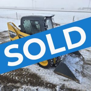 Angled-view-of-a-Gehl-4640-skid-steer-loader-showing-its-protective-cab-tires-with-snow-grip-and-bucket-attachment.-Perfect-for-farming-and-construction-use-in-Western-Canada-sold