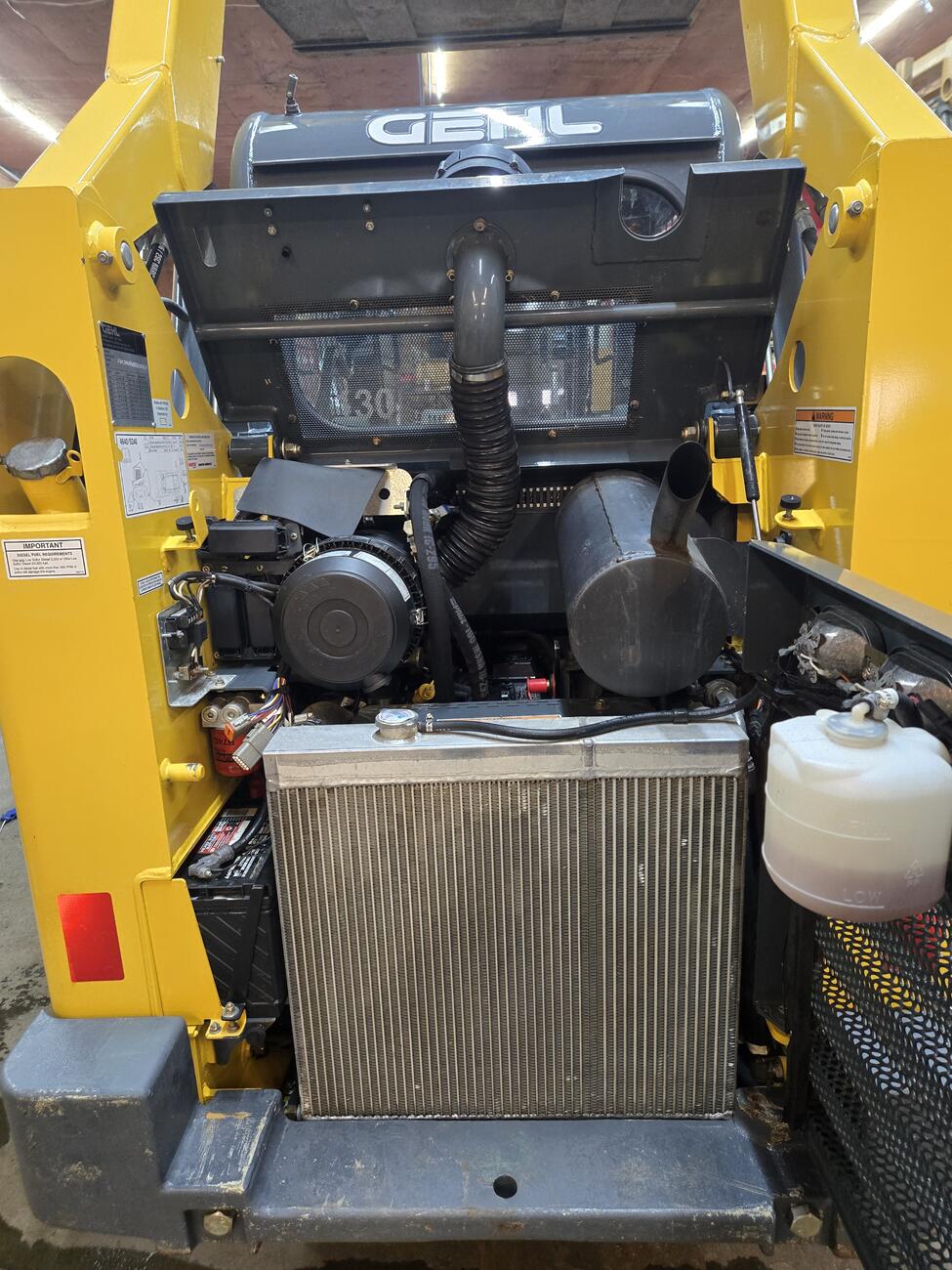 Detailed view of the engine compartment of a Gehl 4640 skid steer loader Ideal for buyers looking for a well-maintained skid steer in Western Canada