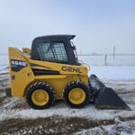 Full side profile of a Gehl 4640 skid steer loader with a bucket attachment, designed for efficient material handling and construction work. For sale in Western Canada.jpg