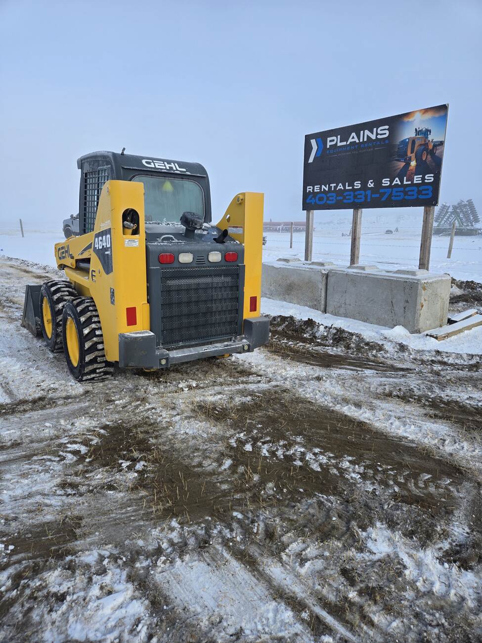 Gehl 4640 skid steer loader parked near a Plains Equipment Rentals sign, showcasing its rear exhaust, taillights, and branding. Available for purchase in Western Canada