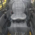 Inside cabin view of a Gehl 4640 skid steer loader Comfortable and well-maintained for efficient operation. Located in Western Canada
