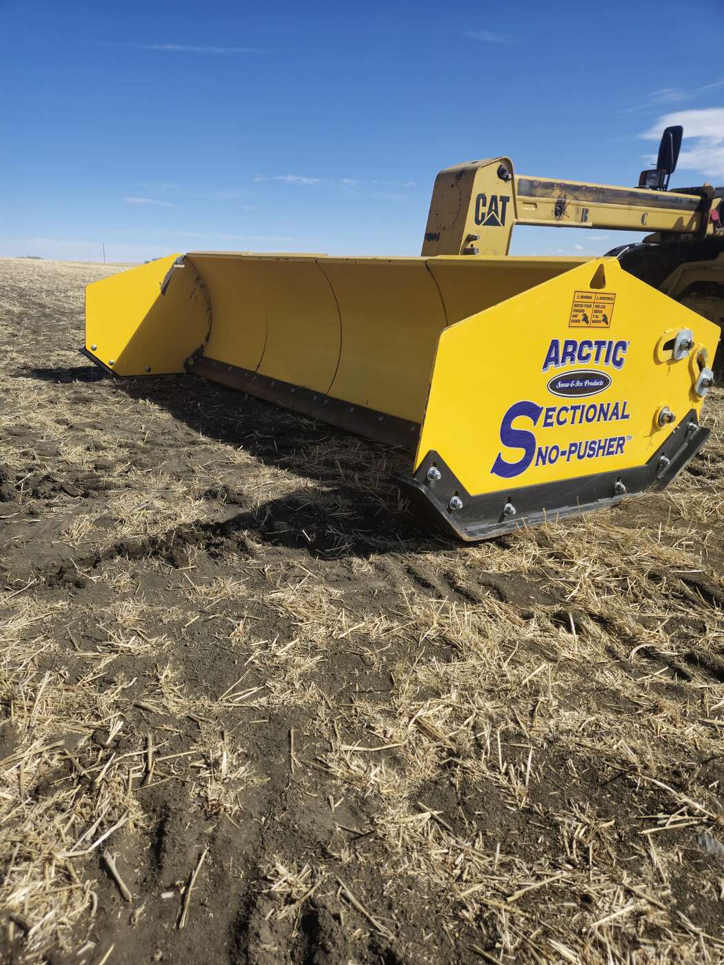arctic-sectional-sno-pusher-10-5hd-side-view-mounted-on-loader-industrial-snow-pusher-western-canada