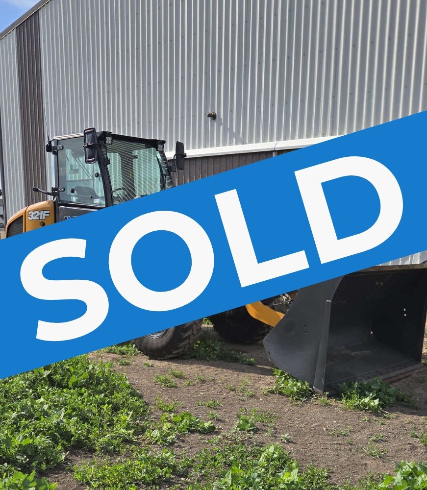 case-321f-wheel-loader-side-profile-near-building-western-canada-construction-equipment-sold