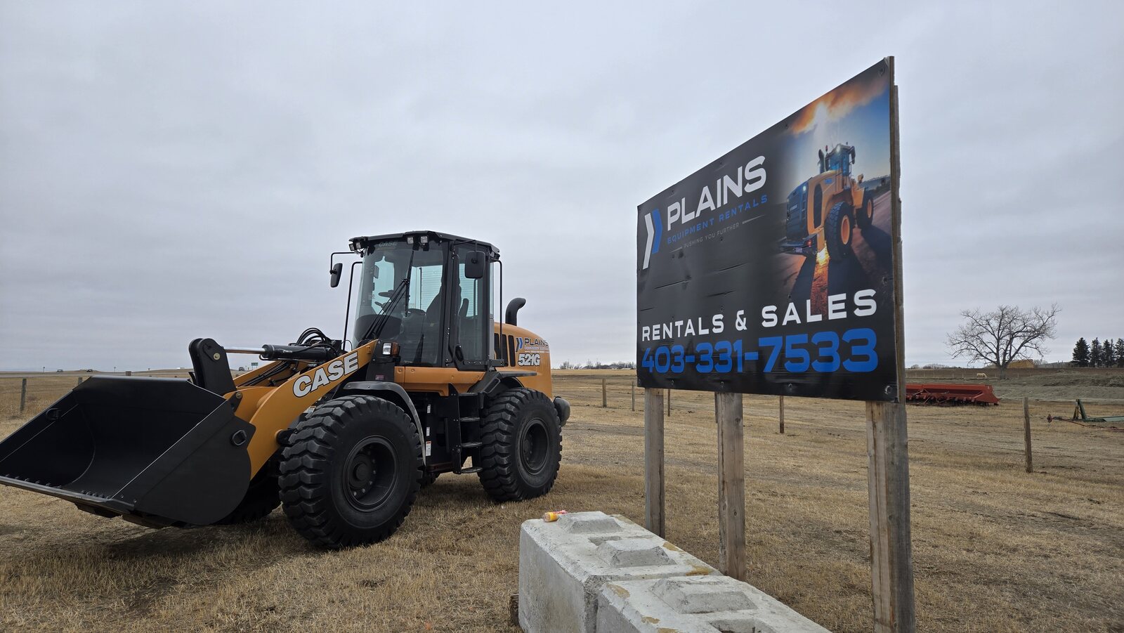 case-521g-wheel-loader-in-front-of-plains-equipment-rentals-sign-heavy-equipment-sales-and-rentals-alberta-canada