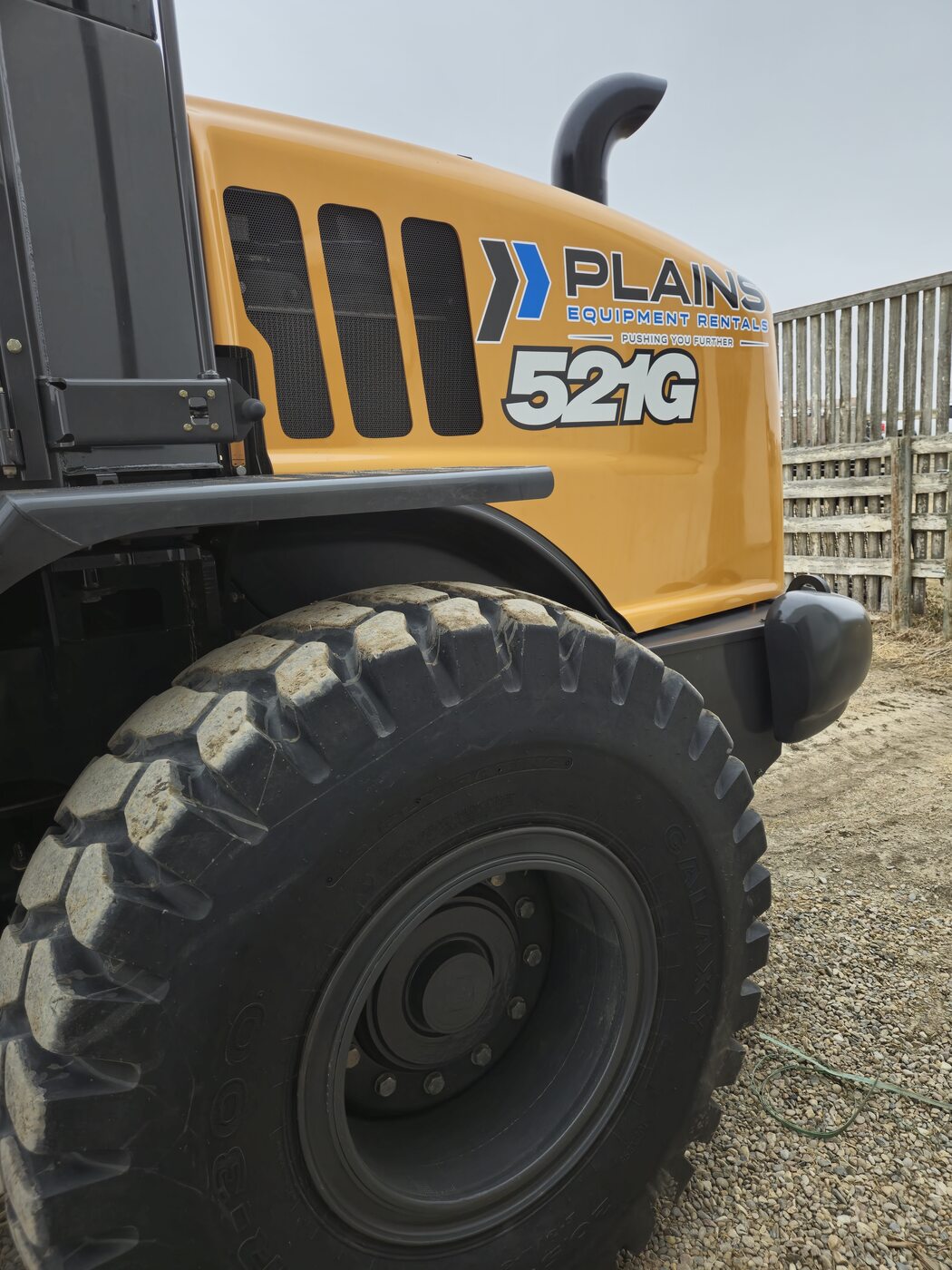 side-panel-and-tires-case-521g-wheel-loader-plains-equipment-rentals-logo-western-canada