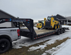 skid-steer-on-bed-truck-for-equipment-rental-delivery-in-western-canada