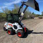 2022-bobcat-l28-loader-on-gravel-yard-articulated-bucket-raised-for-sale-western-canada