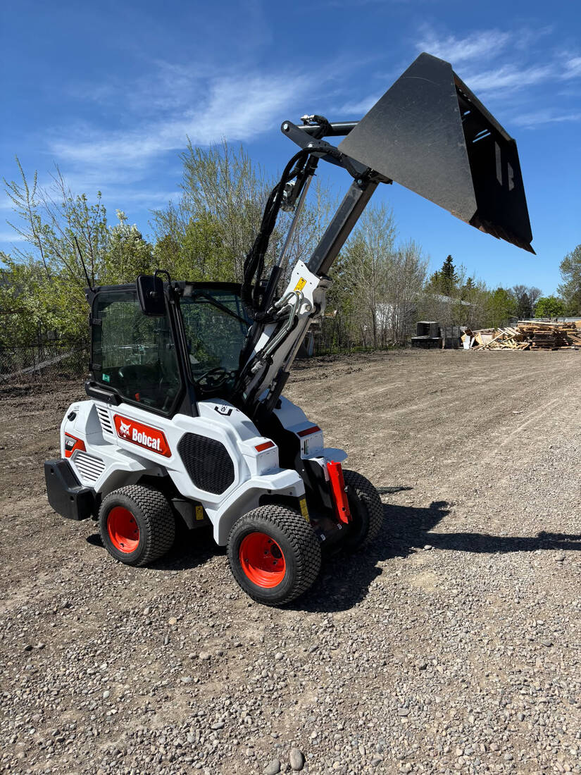 2022-bobcat-l28-loader-on-gravel-yard-articulated-bucket-raised-for-sale-western-canada