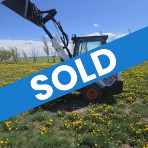 2022-bobcat-l28-small-articulated-loader-for-sale-western-canada-lifted-bucket-side-view-field