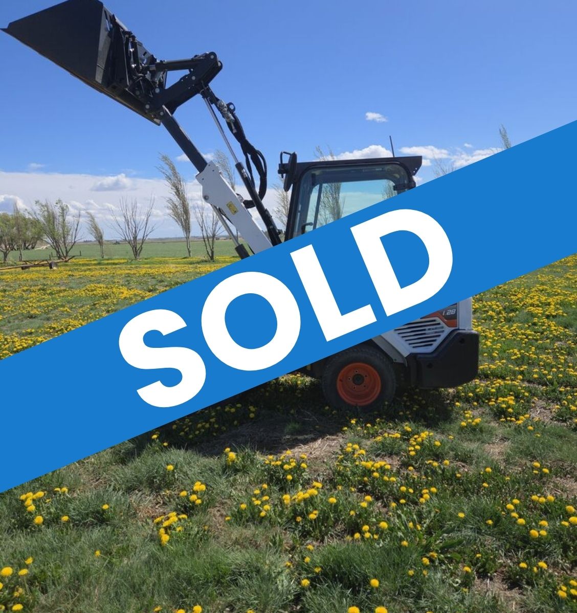 2022-bobcat-l28-small-articulated-loader-for-sale-western-canada-lifted-bucket-side-view-field