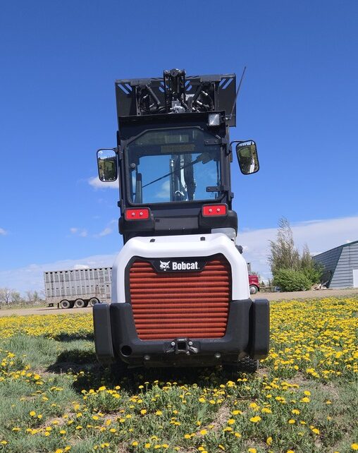 rear-view-2022-bobcat-l28-loader-with-cab-and-lift-arms-raised-for-sale-western-canada