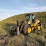 Angled shot of John Deere 524K-II loader with forks attachment, Plains Equipment Rentals, Canada