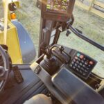 Control panel and joystick inside John Deere 524K-II wheel loader cab, Plains Equipment Rentals