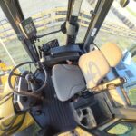Operator’s cab interior of John Deere 524K-II loader showing steering wheel, seat, and controls