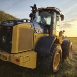 Rear angled view of John Deere 524K-II loader at sunset, Plains Equipment Rentals, Western Canada