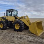 2010 Komatsu WA250-6 with front bucket at low angle showing bucket capacity