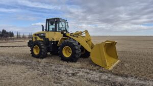 2010 Komatsu WA250-6 with front bucket at low angle showing bucket capacity