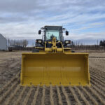 Front bucket view of 2010 Komatsu WA250-6 showing cutting edge and bucket width
