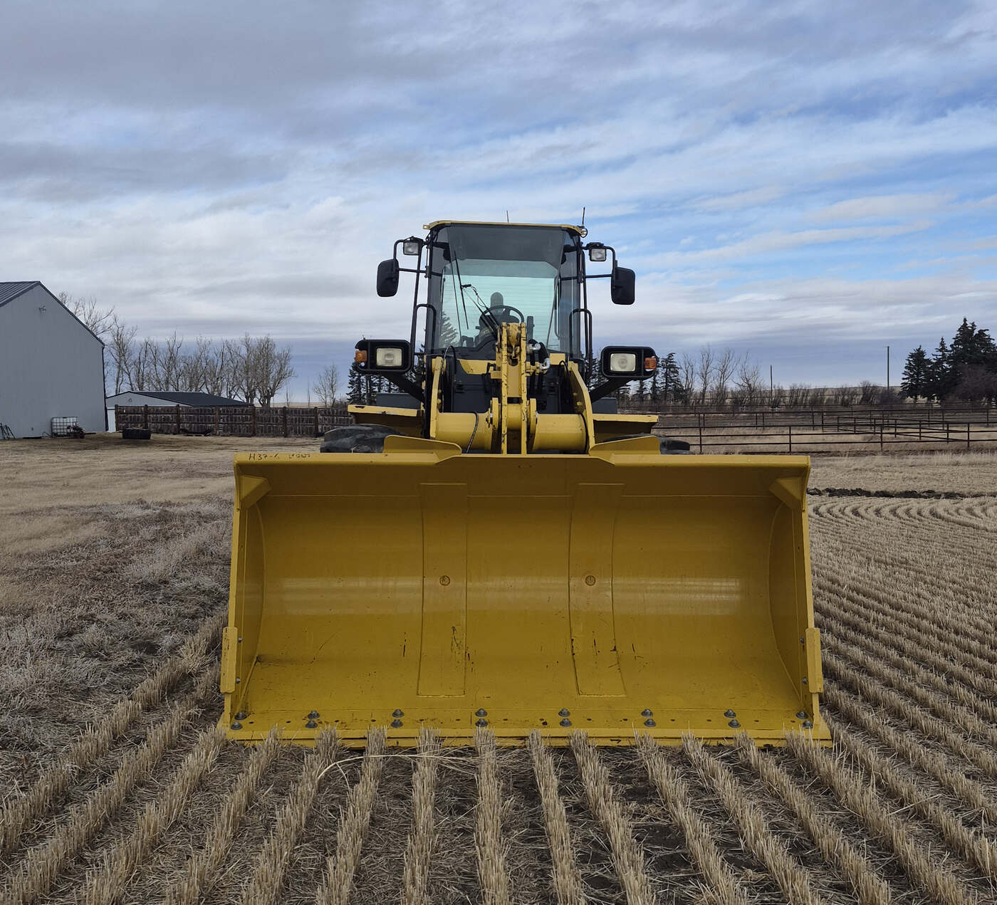 Front bucket view of 2010 Komatsu WA250-6 showing cutting edge and bucket width