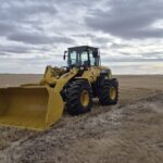 2010 Komatsu WA250-6 wheel loader with front bucket angled in Alberta