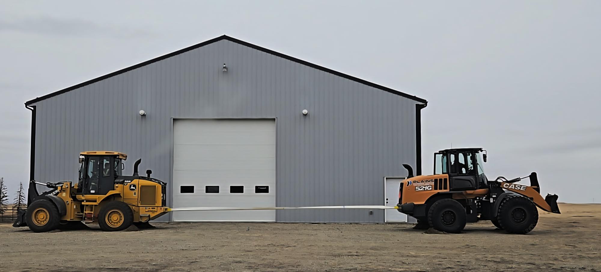 Two heavy loaders positioned outside industrial warehouse building comparison