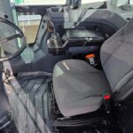 John Deere 444 loader cabin interior showing steering wheel and operator seat for western Canada equipment rental