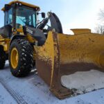 John Deere snow plow equipment for winter road maintenance in western Canada plains