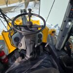 John Deere 444 wheel loader cab interior at Plains Equipment Rentals facility