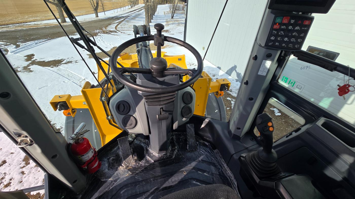 John Deere 444 wheel loader cab interior at Plains Equipment Rentals facility