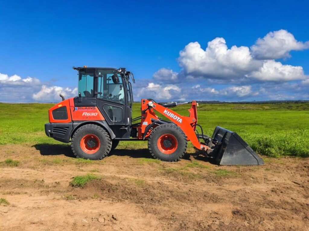 Kubota R640 wheel loader with bucket attachment on prairie field